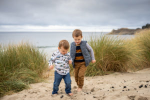 Two little boys are playing on the beach on the Oregon Coast. 