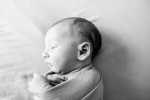 Black and white photo of a newborn baby on a blog titled, "how to prepare for your newborn session."