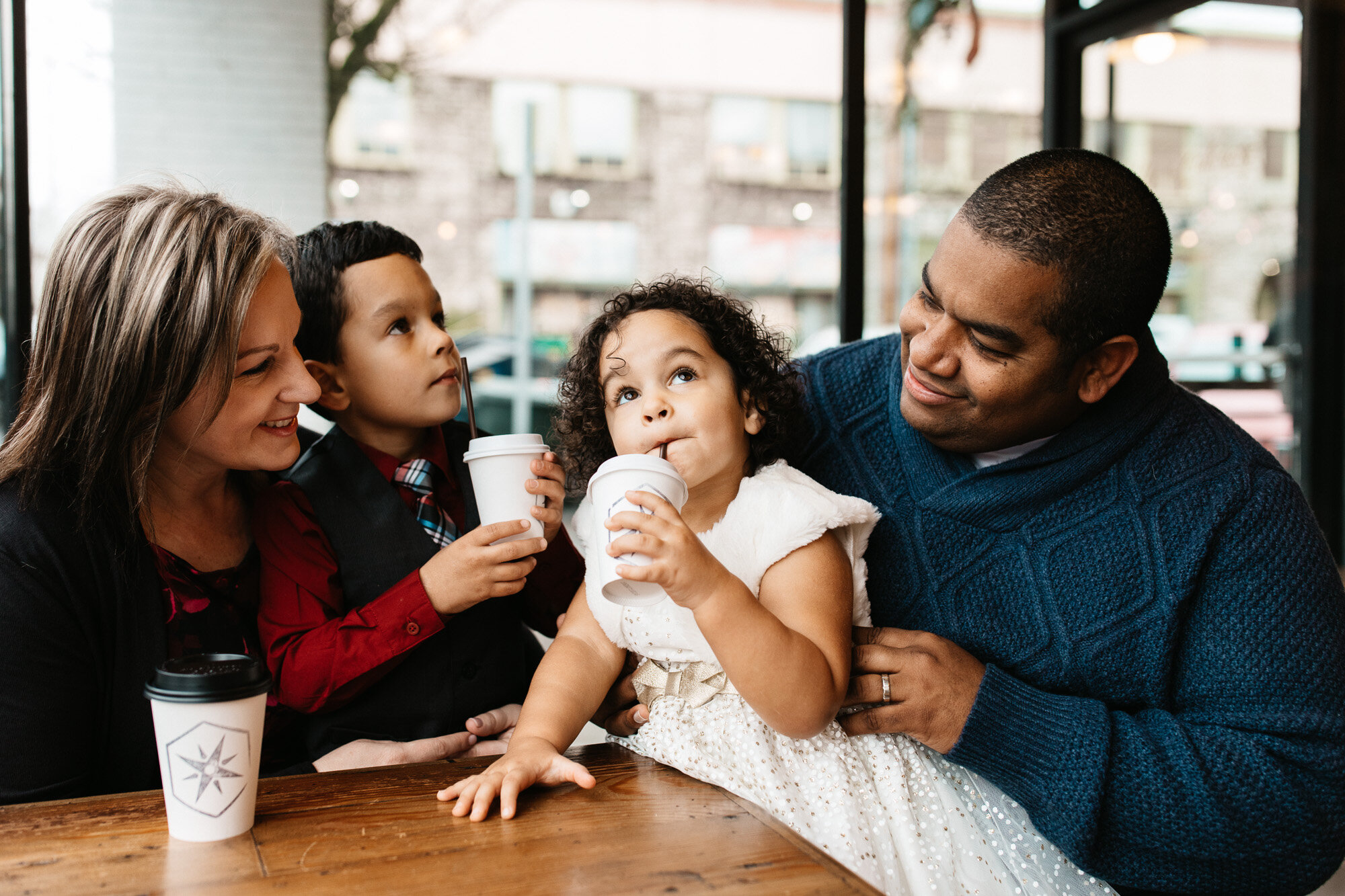 family of four drinking coffee in a coffee shop | coffee shops in vancouver wa