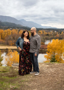 Couple smiling at one another in the Gorge during fall with autumn foliage. 