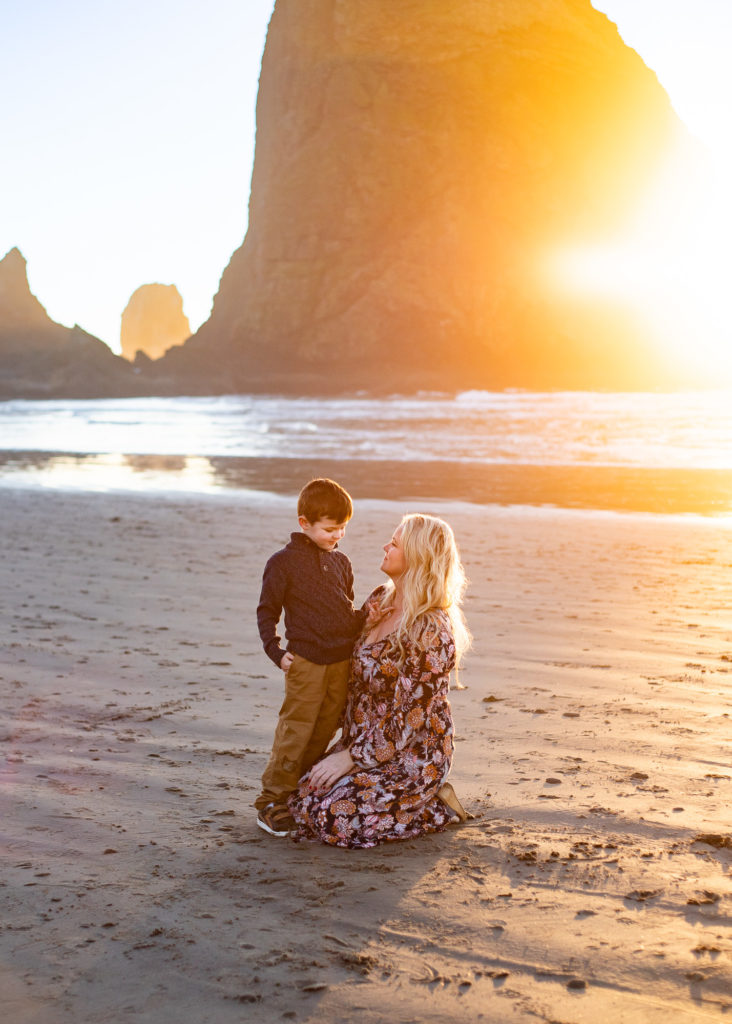 Spas in Cannon Beach | Mom with son watching sunset in front of Haystack rock in cannon beach