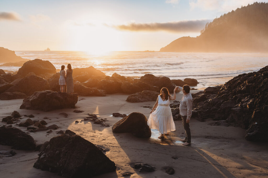 Parents watching their children explore tide pools along the Oregon shoreline.