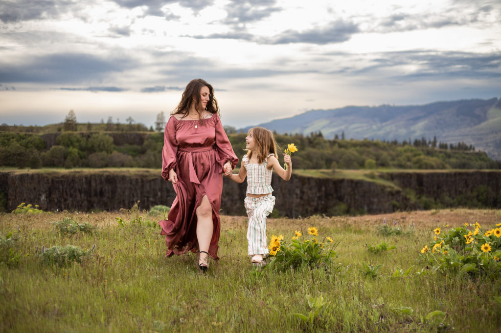 mom and daughter in wildflowers in the Columbia River Gorge | Best hotels in Vancouver Washington 