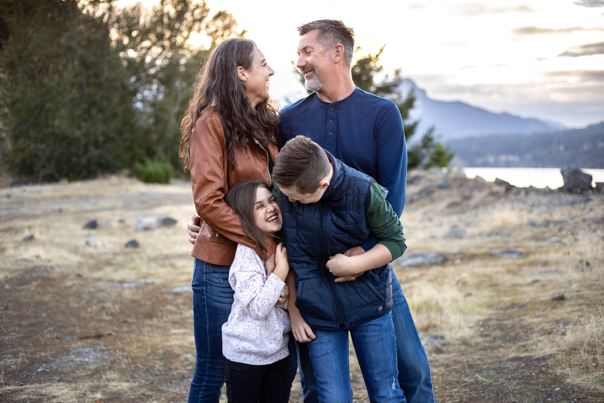 orthodontist vancouver wa | family of four laughing on the rocks in the Columbia river gorge