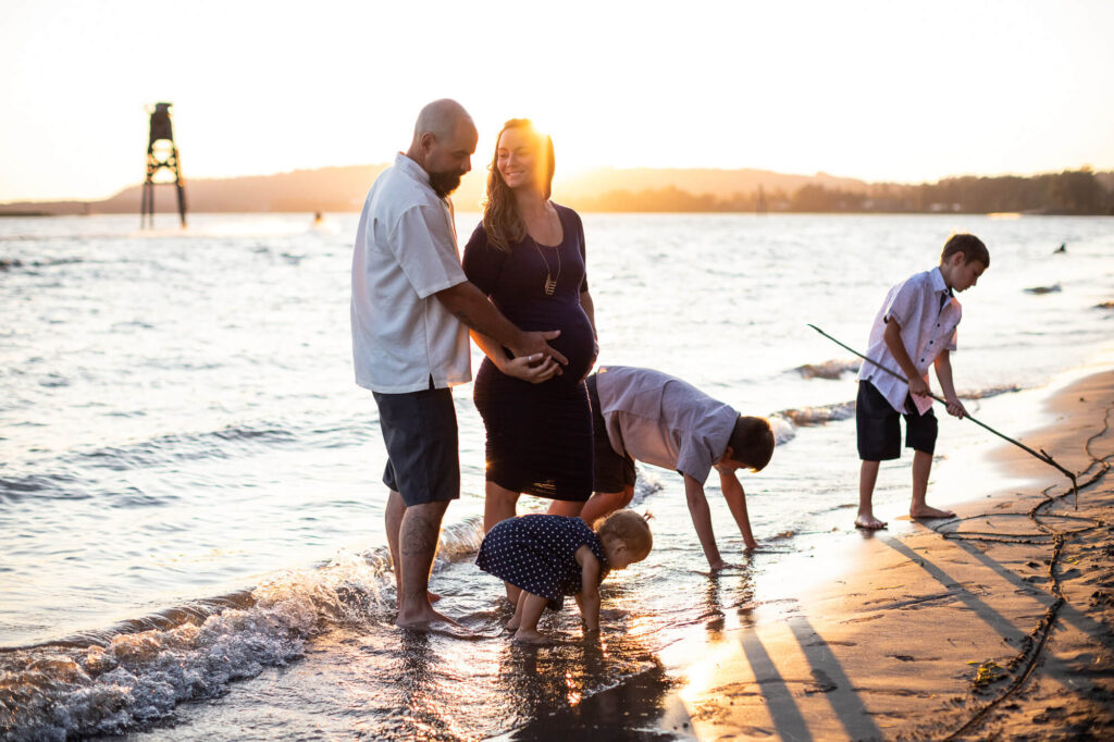 Pregnant mom with family at sunset on the beach | Portland Maternity Clothes