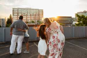 Mother and daughter touching foreheads in the sunset on top of parking garage in downtown Vancouver, WA
