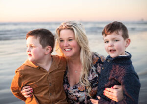 mother and sons smiling at sunset on Cannon Beach, Oregon. 