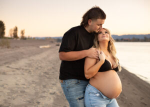Expecting parents stand on beach near portland oregon. Portland Prenatal Yoga 