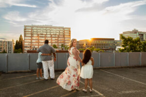 Family of four watching the sunset on the top of a parking garage in Vancouver, Wa. | Kids Activities in Vancouver, Wa