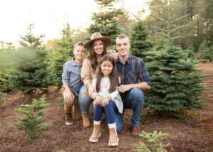 Family photo of PNW family at a local tree farm for holiday photos. 