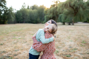 Son hugged his mother in a family photo shoot in PNW park for a family photo shoot. 