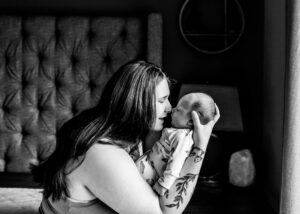 Black and white image of mom with newborn son touching noses. Portland baby photographer. 