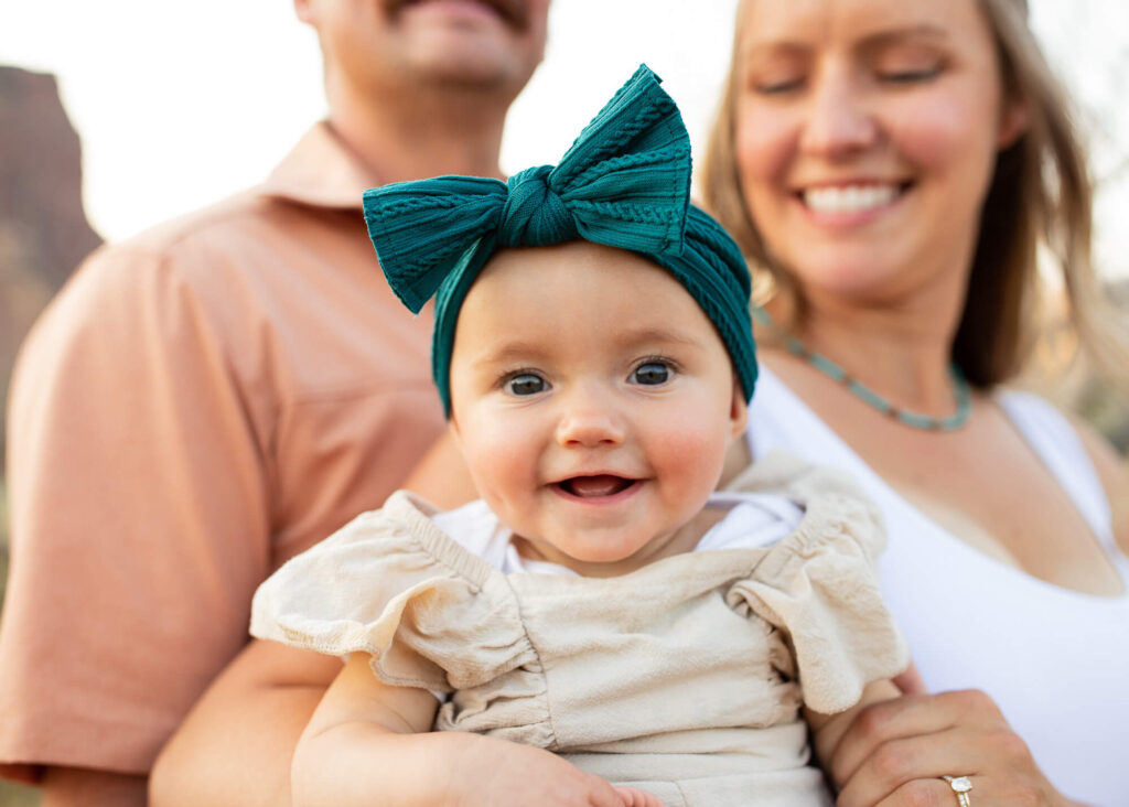 Infant smiling with parents in Oregon. Portland pediatricians. 