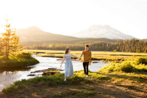 Couple walking in meadow at sunset in front of South Sister, Oregon. Things To Do in Sunriver, Oregon, in Summer