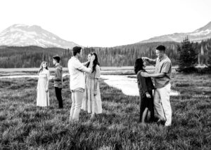 A black and white image of an extended family standing in front of South Sister in Bend, Oregon. 