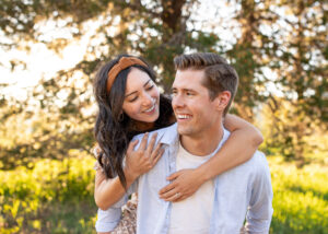 Young couple at Soda Creek, Oregon, in extended family photo shoot. Things to do in bend, Oregon with kids.