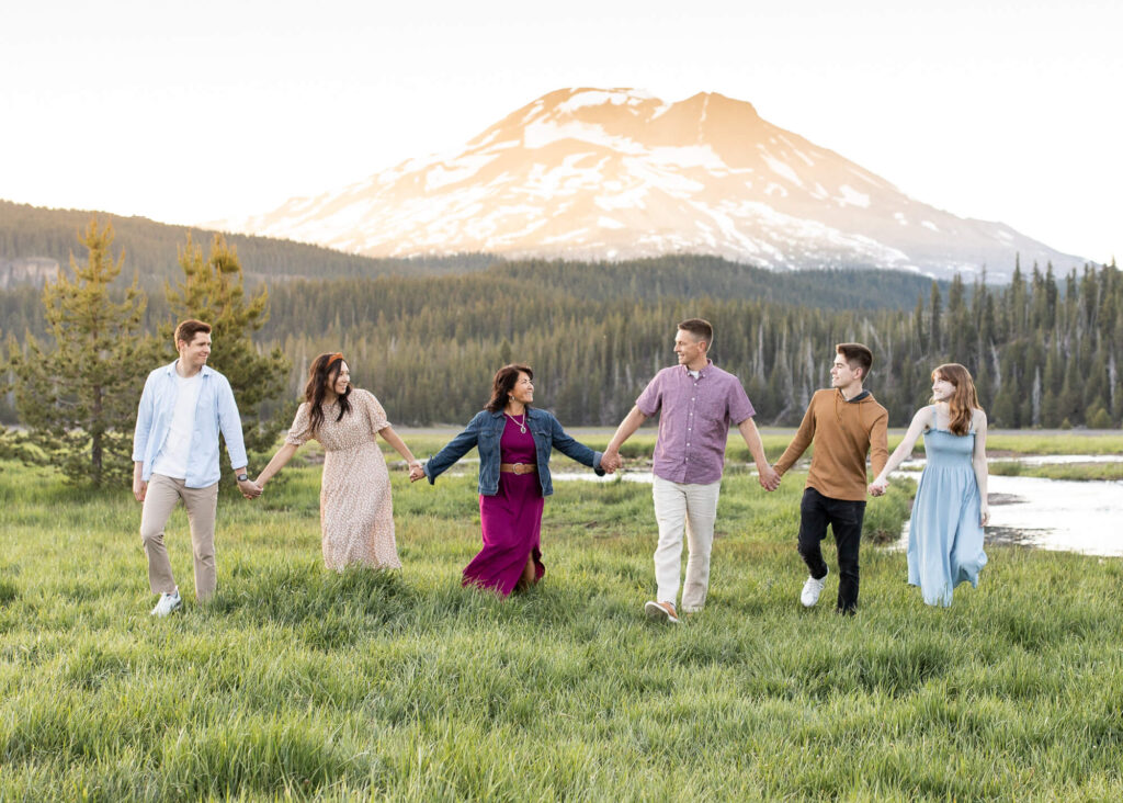 A family of 6 walking through a meadow at Soda Creek, Oregon. 