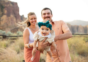 Family of three with an infant at Smith Rock State Park, Oregon. Things to do in Bend, Oregon, with kids. 