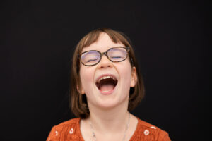 Little girl laughing out loud on school picture day near Portland, Oregon. 