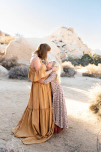 Mom and daughter looking at one another while having family photos in Joshua Tree. 