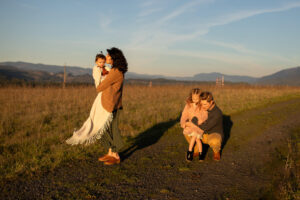 A family playing in a field during their winter family photos.