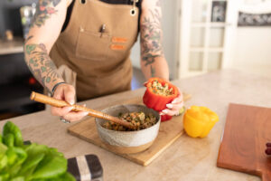 Portland gluten-free, vegan chef prepares stuffed pepper quinoa. 