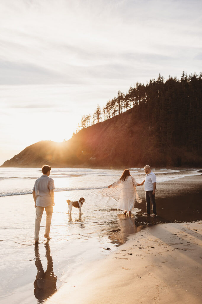 Family enjoying a peaceful evening on the Oregon Coast with their dog.