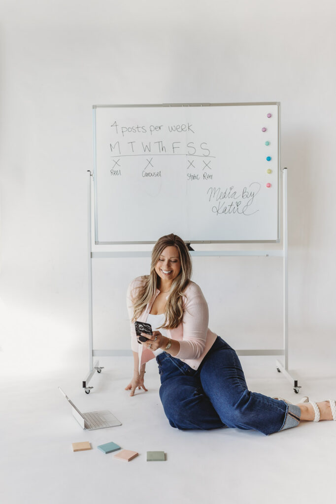 social media strategist photoshoot in a clean white studio with creative props.
